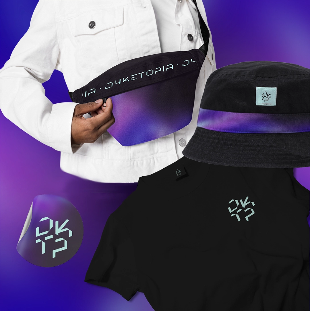 Mockup of Dyketopia promotional items including a fanny pack, hat, t-shirt, and sticker with the logo.