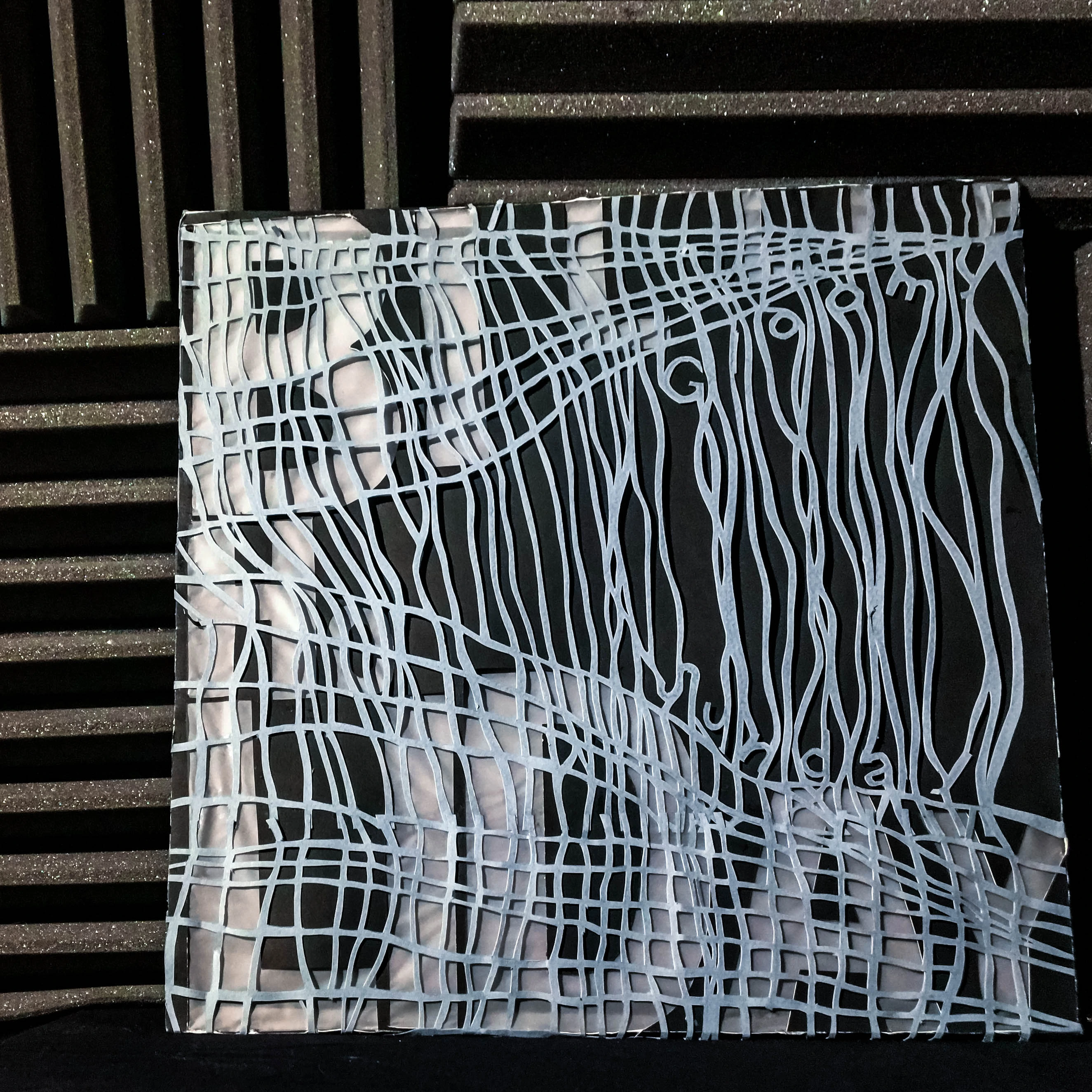 Front view of the vinyl cover with a complex weave of white threads.